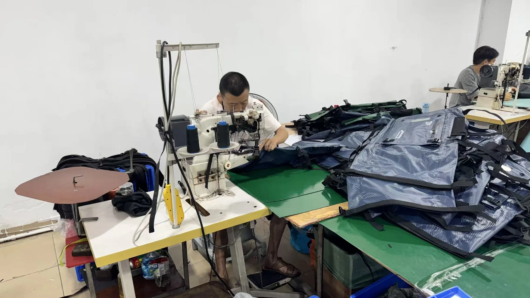 DryCross factory workers sewing waterproof bags during a production run for low-MOQ sourcing planning
