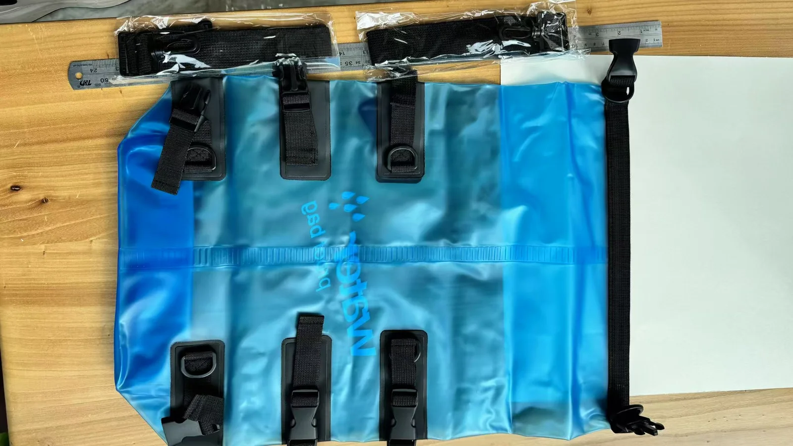 Translucent blue waterproof bag photographed for material and finish evaluation