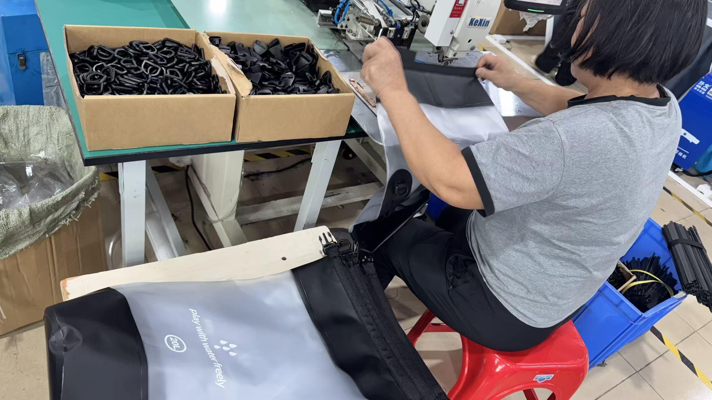 DryCross worker fitting buckles and hardware to waterproof bags