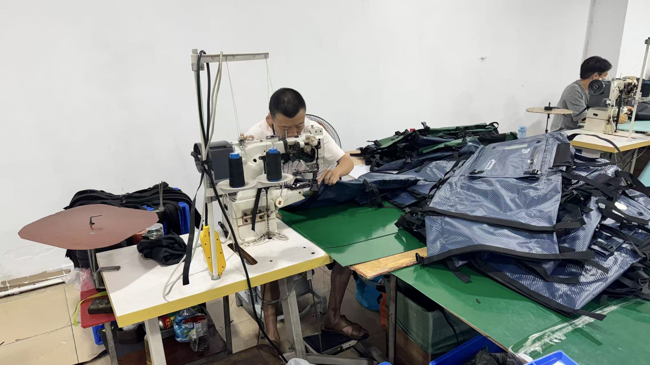 DryCross workers sewing a batch of waterproof bags