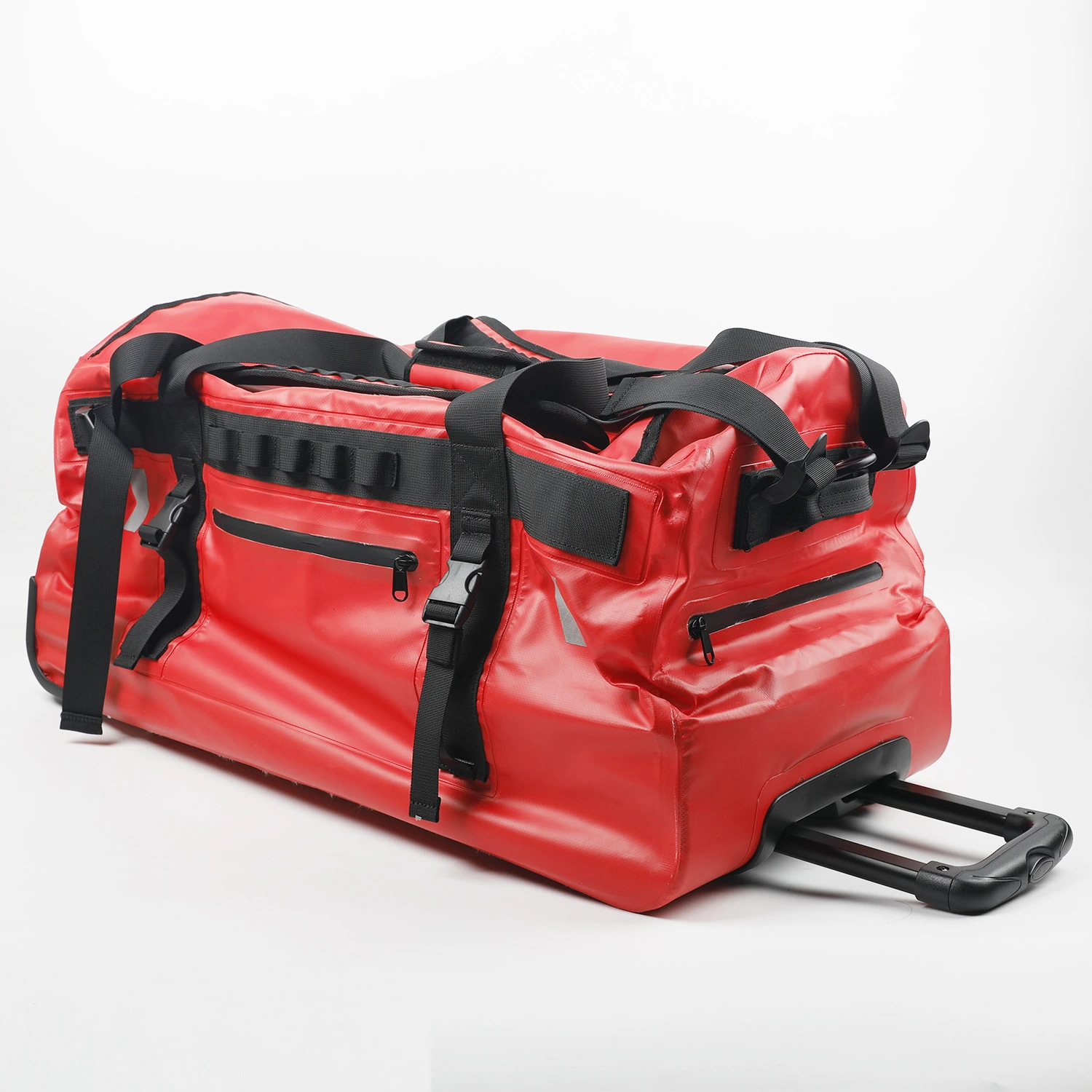 Red wheeled waterproof duffel with webbing handles straps and telescopic trolley handle